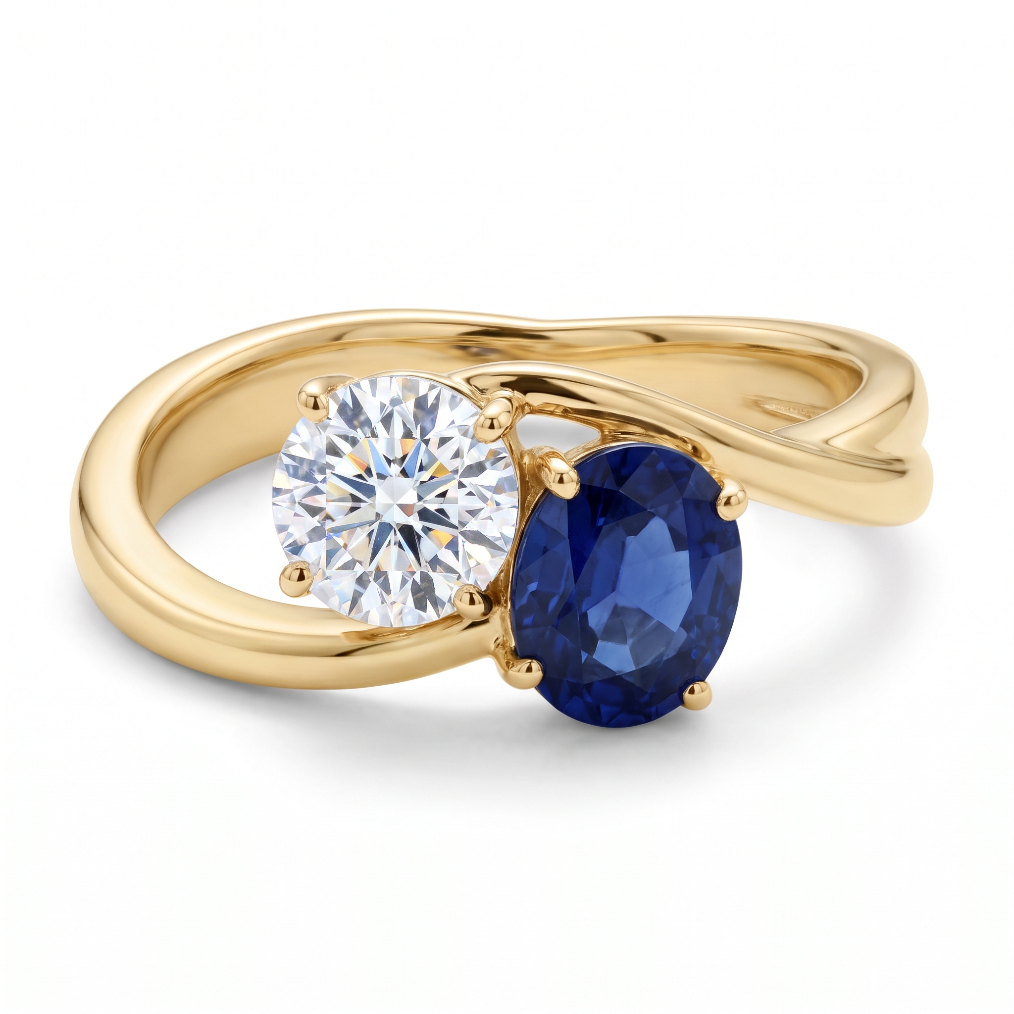 A yellow gold toi et moi ring with a round brilliant diamond and an oval blue sapphire facing each other on a crossover band