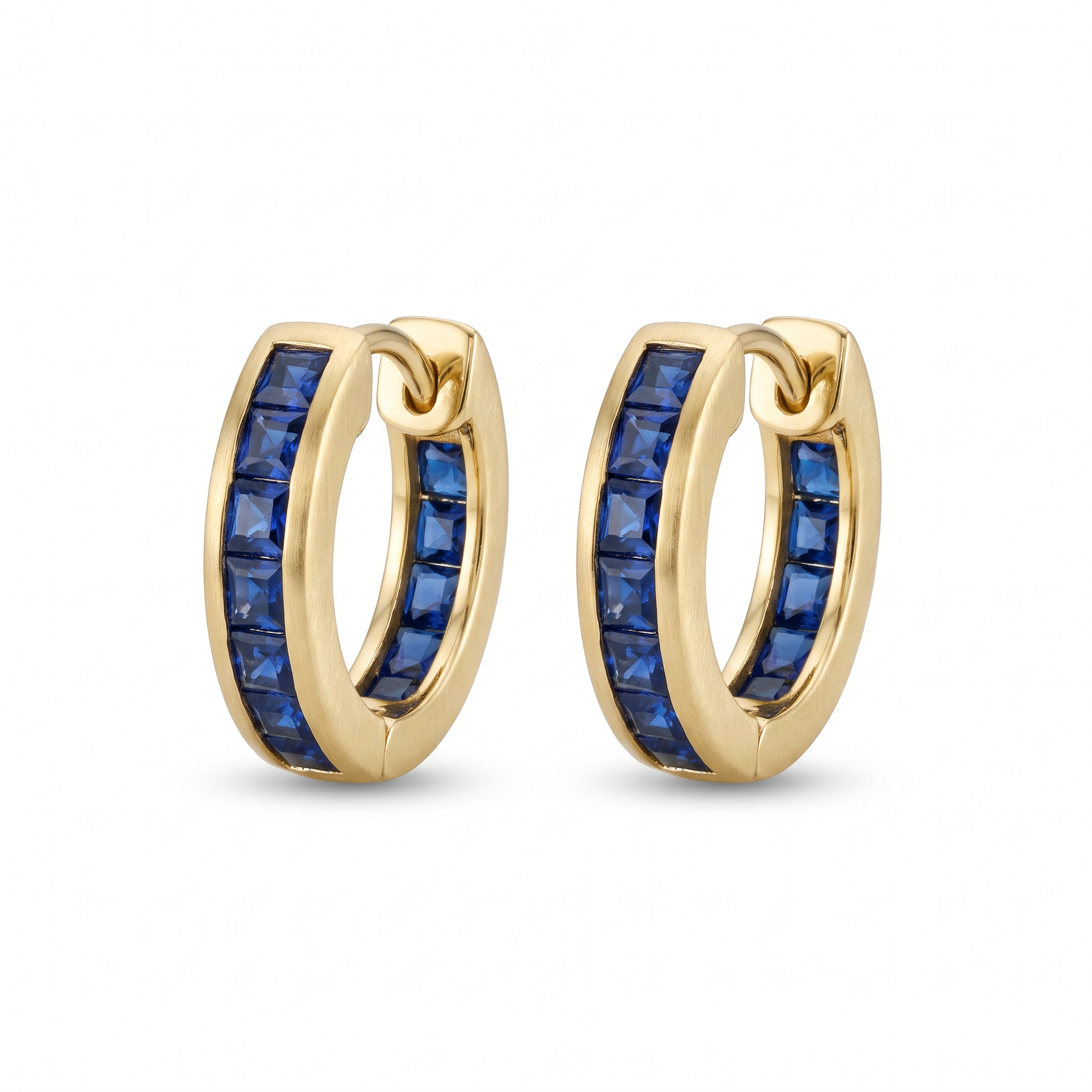A pair of gold huggie hoop earrings channel-set with square deep blue sapphires