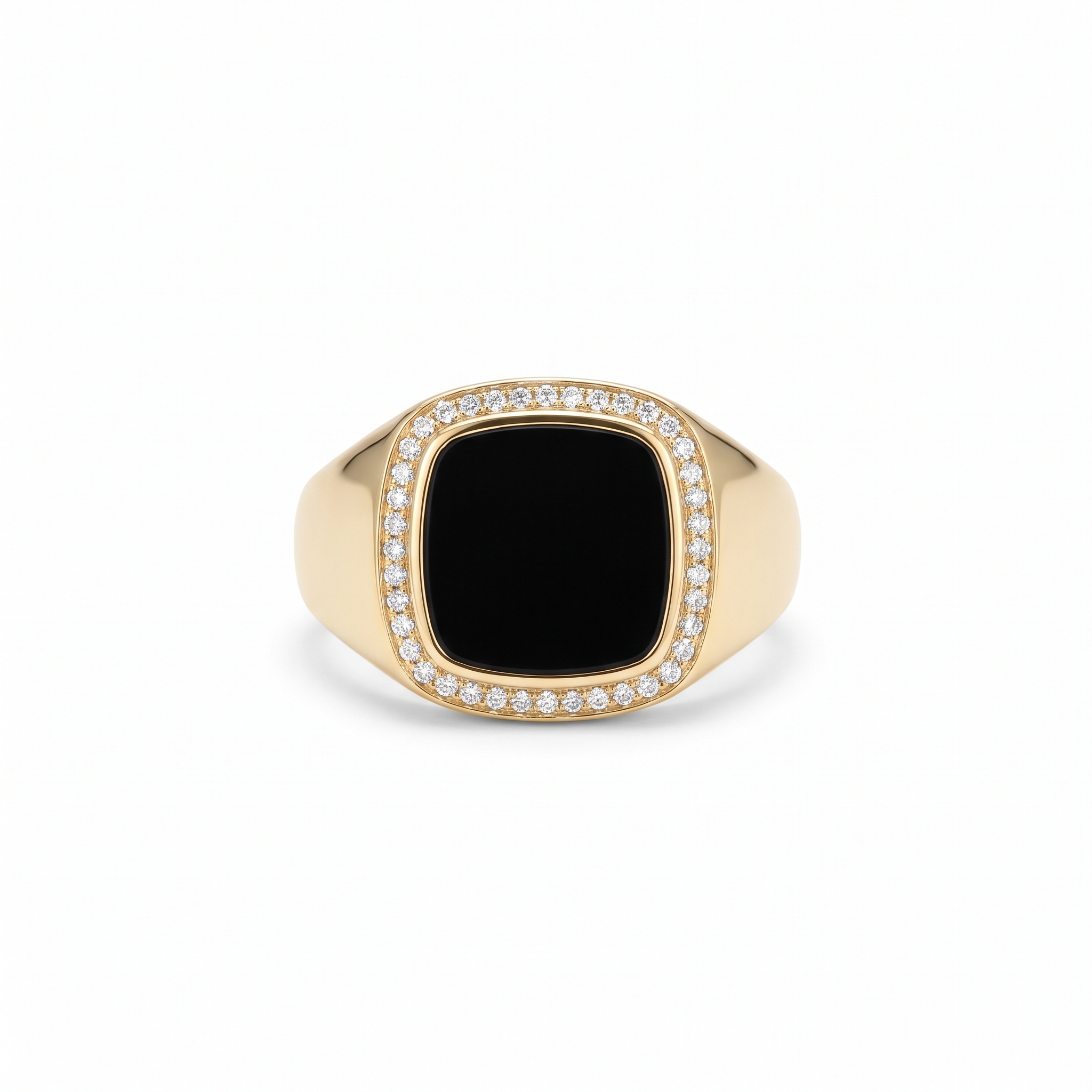 A yellow gold signet ring with a cushion black onyx face inside a thin diamond bezel